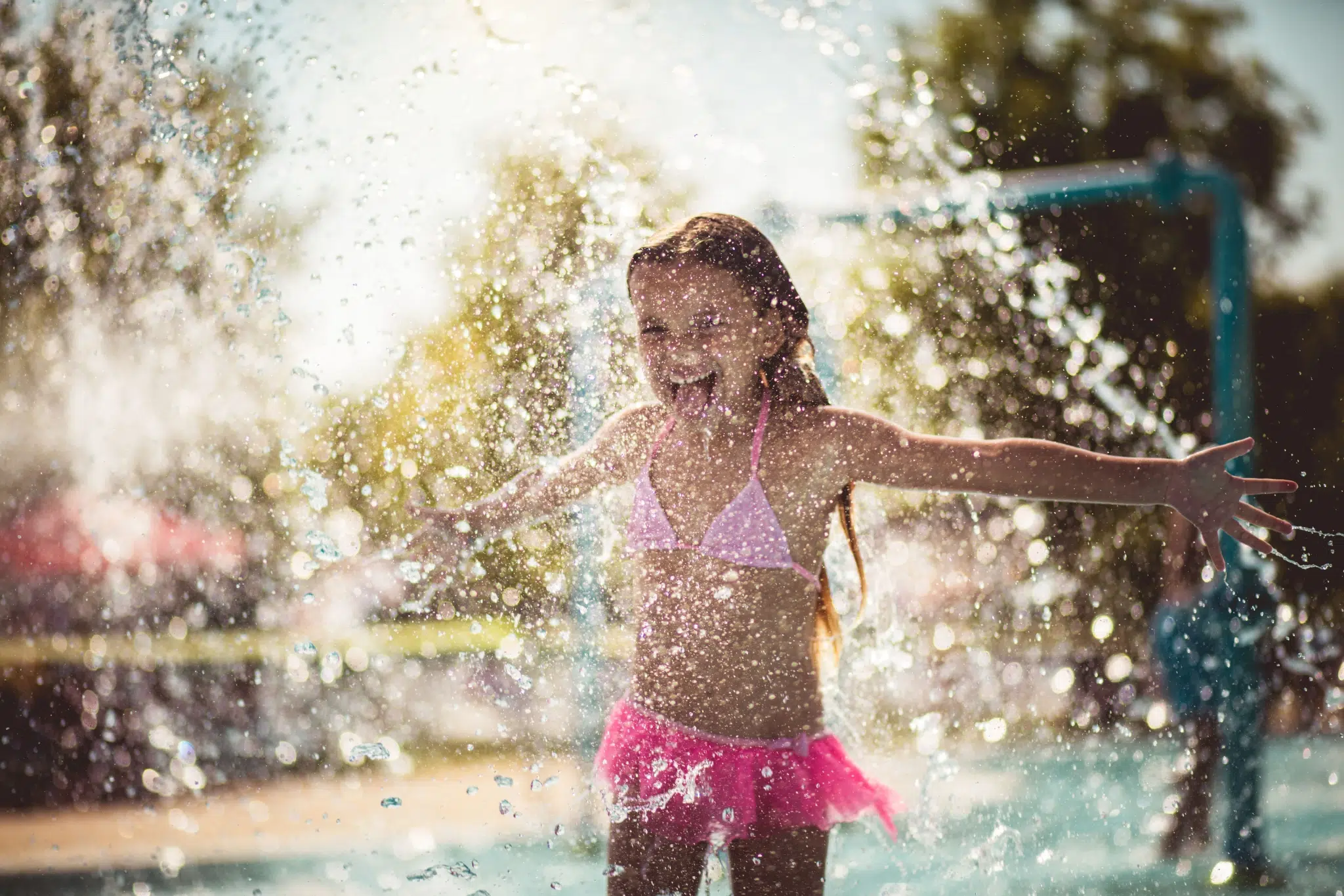 Ihr seht ein Mädchen im Pool. JUFA Hotels bietet tollen Sommerurlaub an schönen Seen für die ganze Familie.