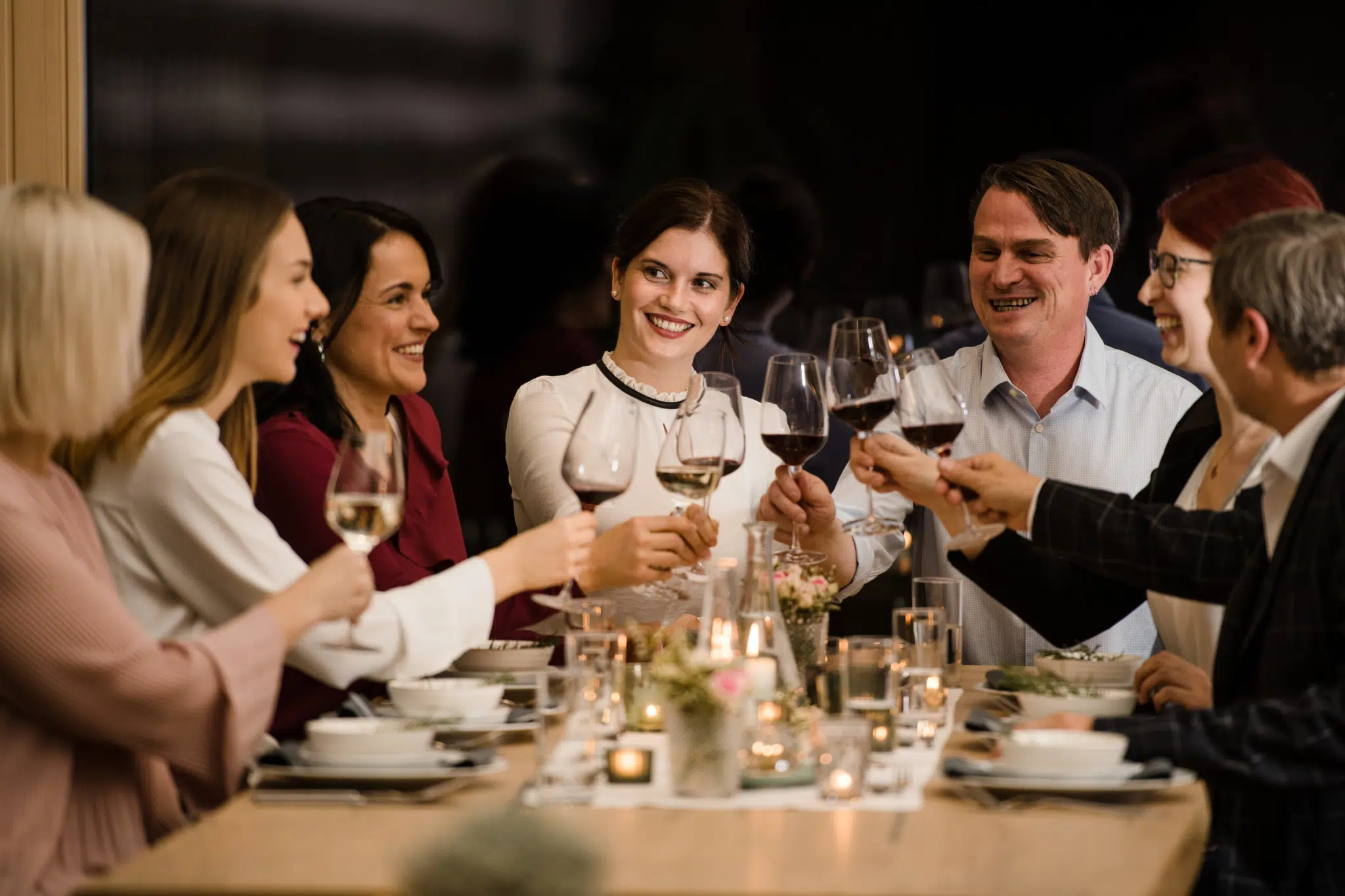 Gäste beim Abendessen mit Wein im EventArium am JUFA Hotel Neutal – Landerlebnis. Der Ort für erlebnisreichen Natururlaub für die ganze Familie.