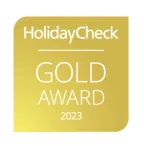 Ihr seht die Auszeichnung des HolidayCheck Gold Awards für das Jahr 2023.