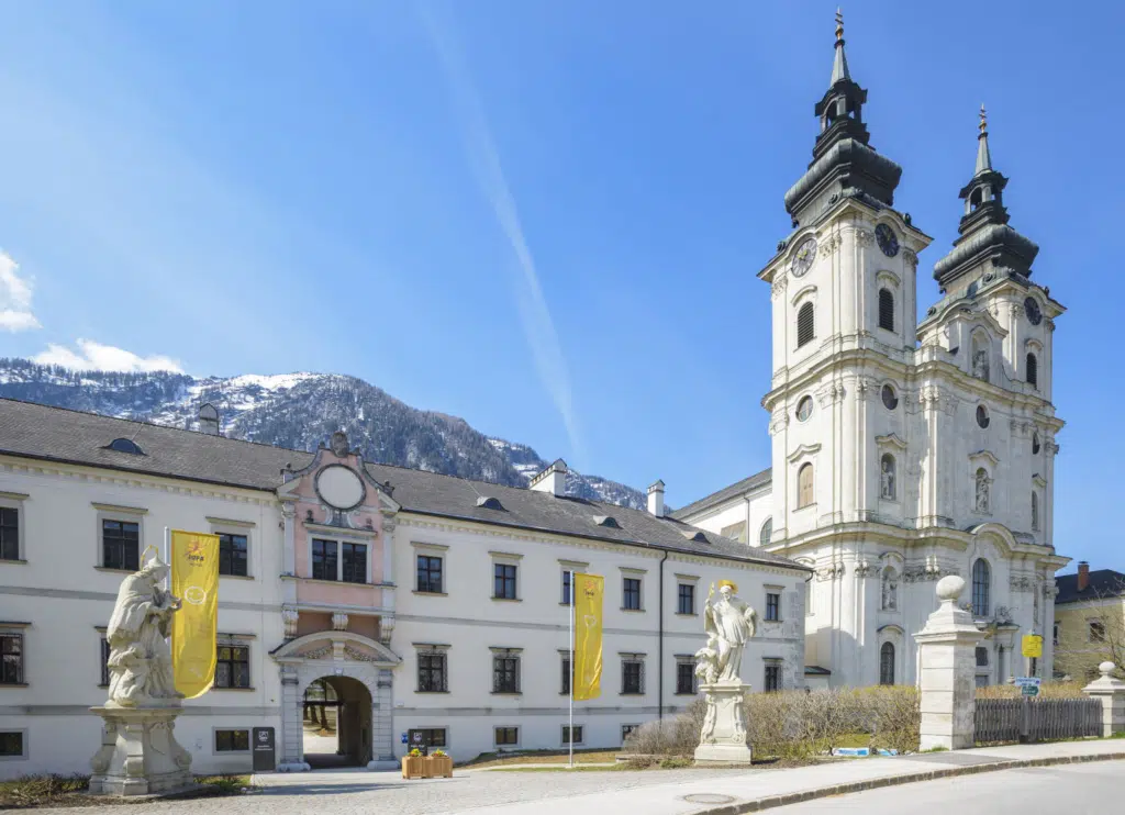 Hotelansicht mit Stiftstürmen im Sommer vom JUFA Hotel Spital am Pyhrn***.