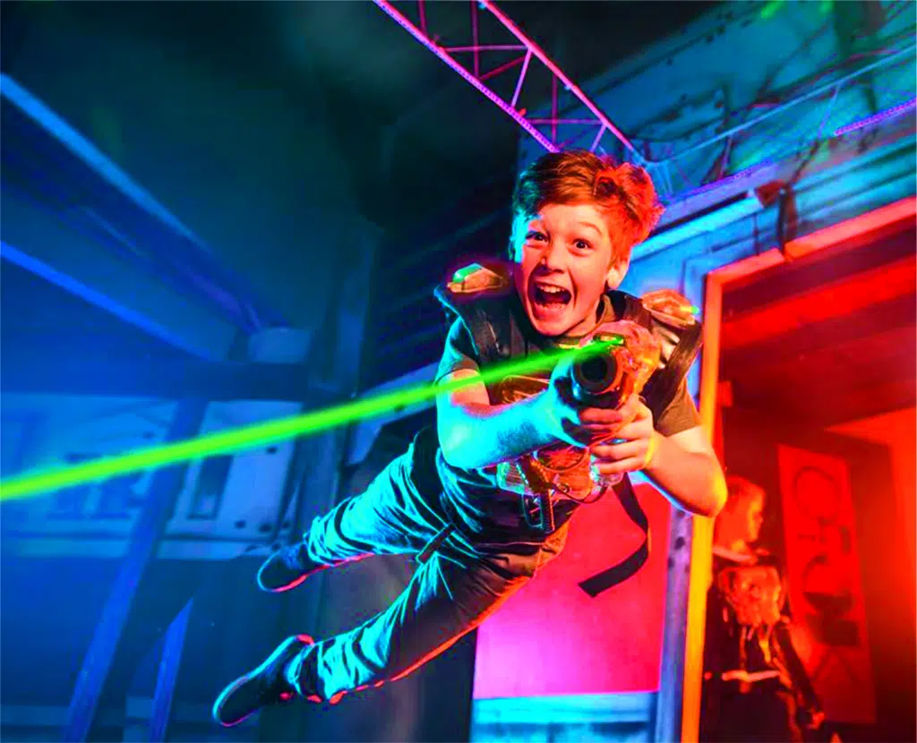 Ihr seht einen Jungen beim Laser Tag in der Laser Area der Playworld Spielberg, die sich ganz in der Nähe der JUFA Hotels im Murtal befindet.