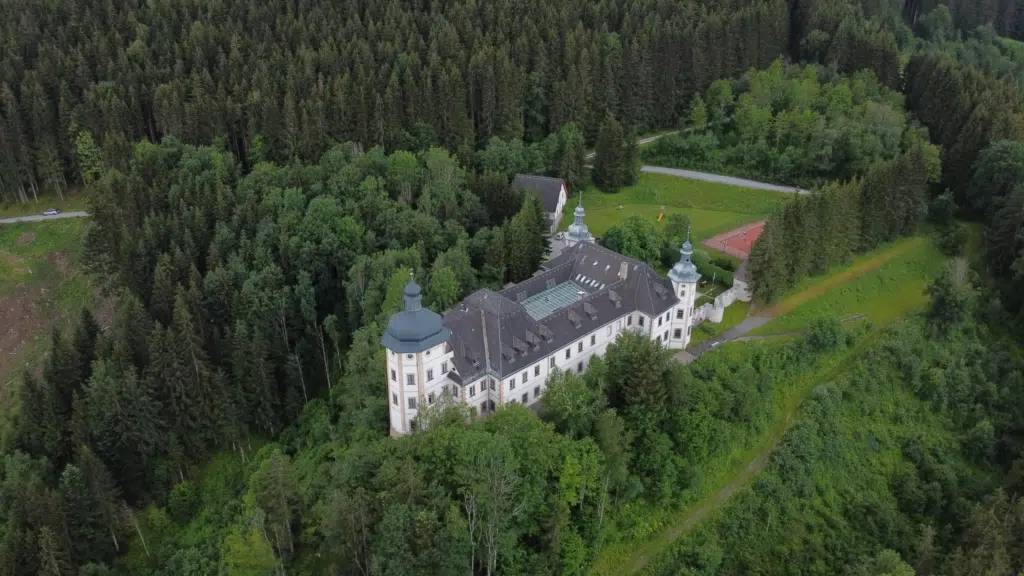 Ihr seht eine Luftaufnahme des JUFA Hotels Schloss Röthelstein. Der Ort für erholsamen Familienurlaub und einen unvergesslichen Winter- und Wanderurlaub.