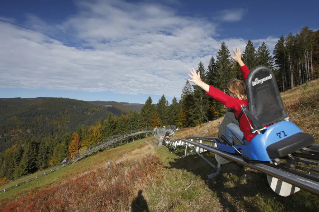 Ihr seht eine Frau beim Fahren der Sommerrodelbahn Hasenhorn Coaster in Todtnau.