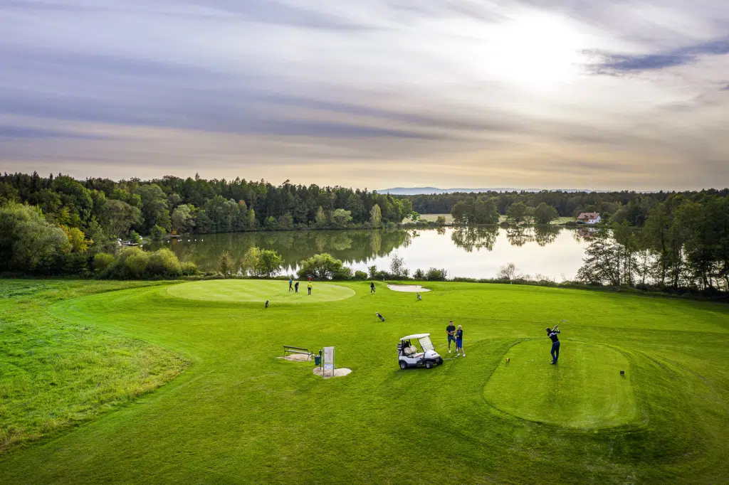 Ihr seht ein Bild aus dem Golfclub Traminergolf in Klöch in der Nähe von Bad Radkersburg mit einem idyllischen Teich im Hintergrund.