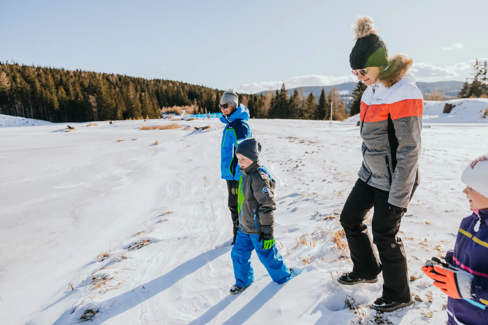 Ihr seht eine Familie beim Winterwandern auf der Hebalm im Schilcherland.