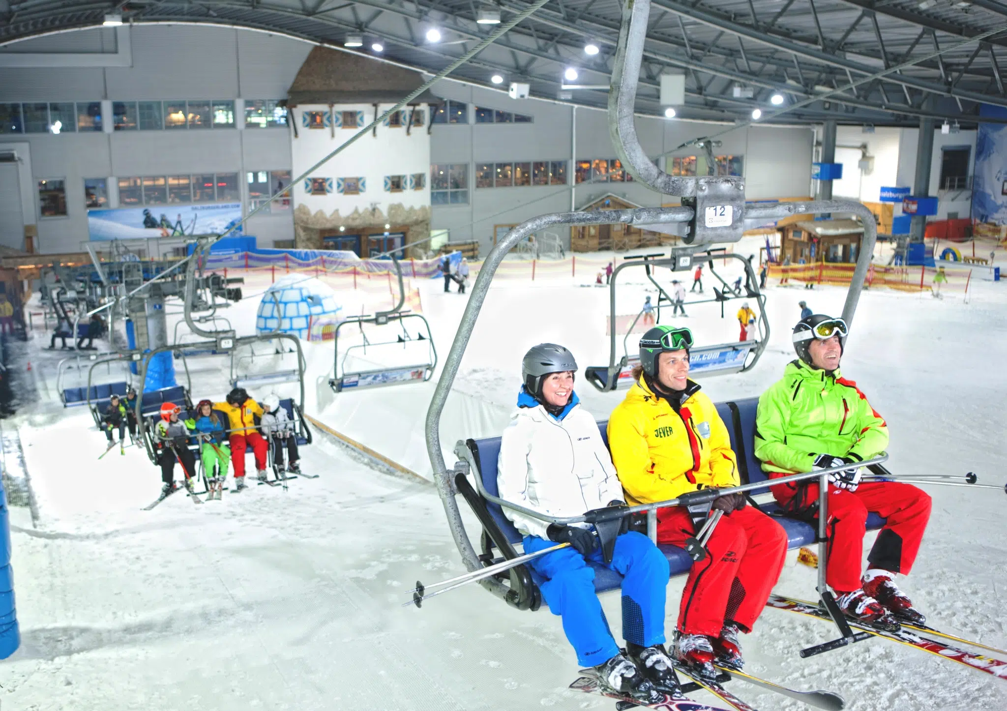 Erwachsene und Kinder auf Sessellift in der Skihalle Neuss in Nordrhein-Westfalen. JUFA Hotels bietet kinderfreundlichen und erlebnisreichen Urlaub für die ganze Familie., #045, erwachsene, kinder, nordrhein-westfalen, nrw, schnee, sessellift, skihalle, skihalle neuss, skilift