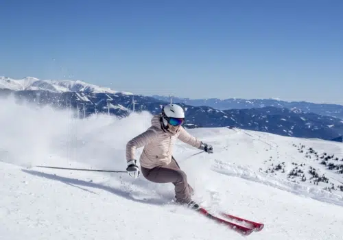 Ihr seht eine Frau beim Skifahren.